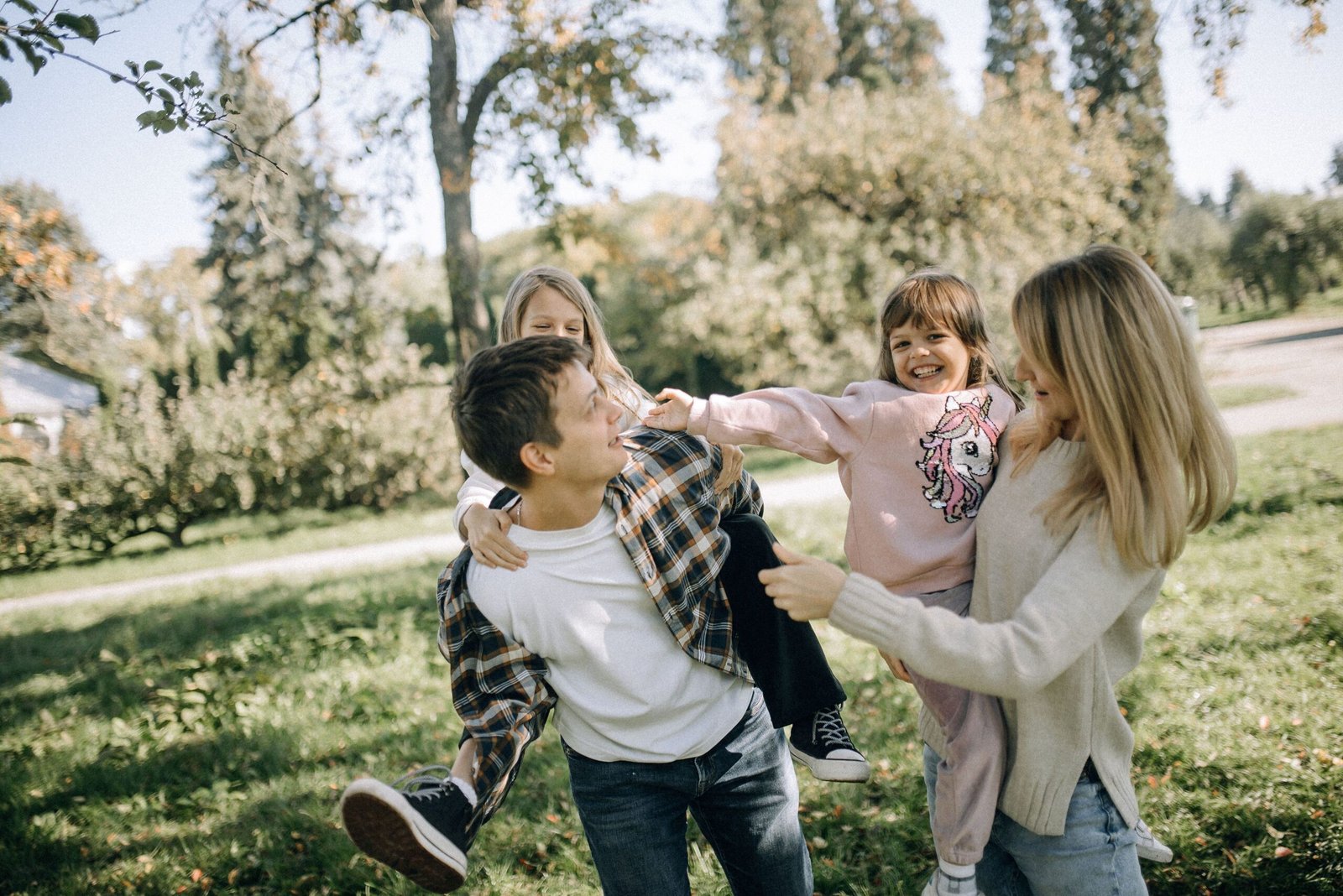 Home A joyful family spending quality time together in a green park on a sunny day.